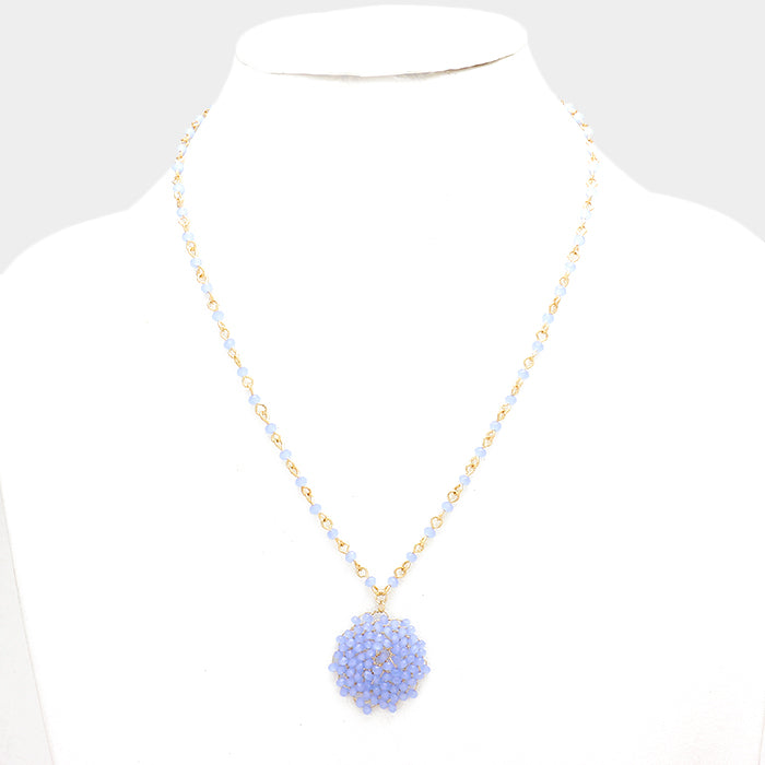 Glass bead pinwheel pendant necklace