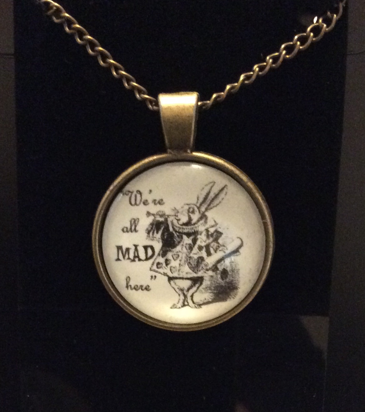 Glass Cabochon “We’re all mad here” Bezel Set Necklace Bronze